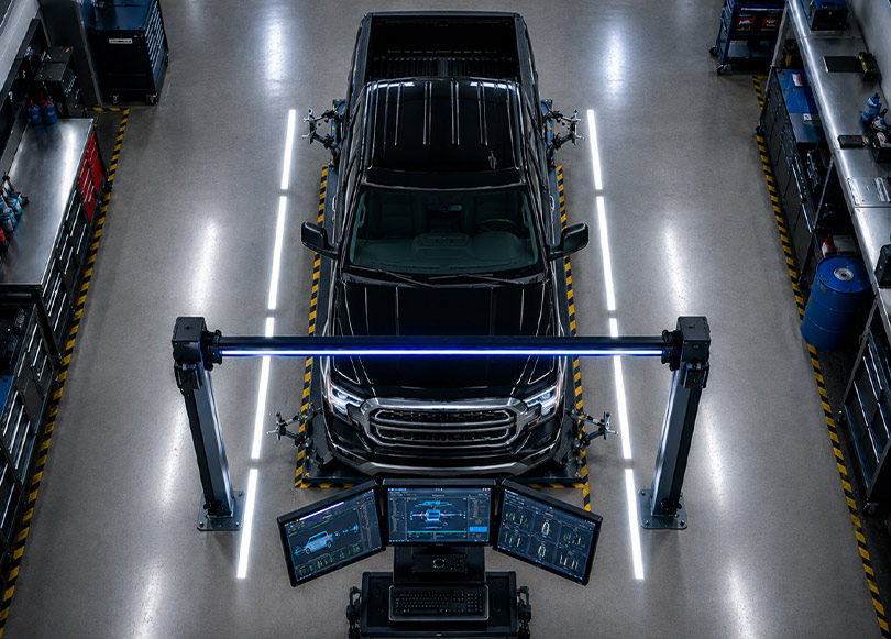 Technician inspecting the underside of a vehicle