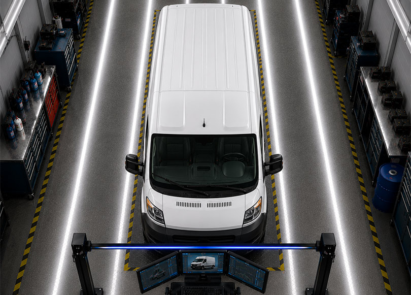 Technician inspecting the underside of a vehicle