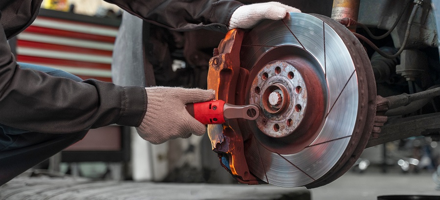 Technician inspecting a tire in the service bay