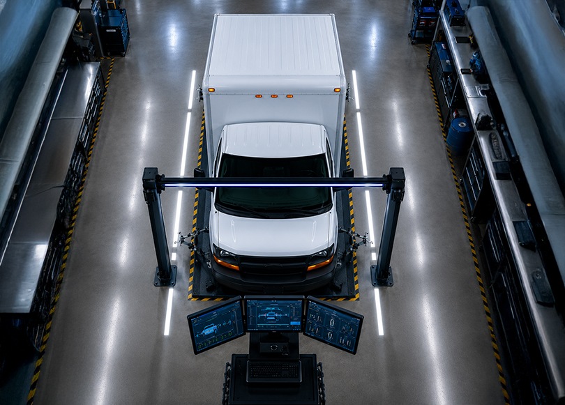 Technician inspecting the underside of a vehicle