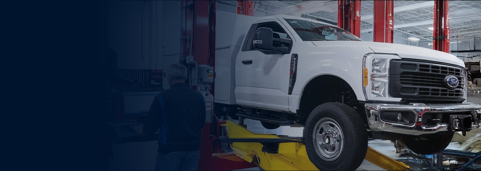 Truck being serviced on a lift in a Ford Pro Elite service bay