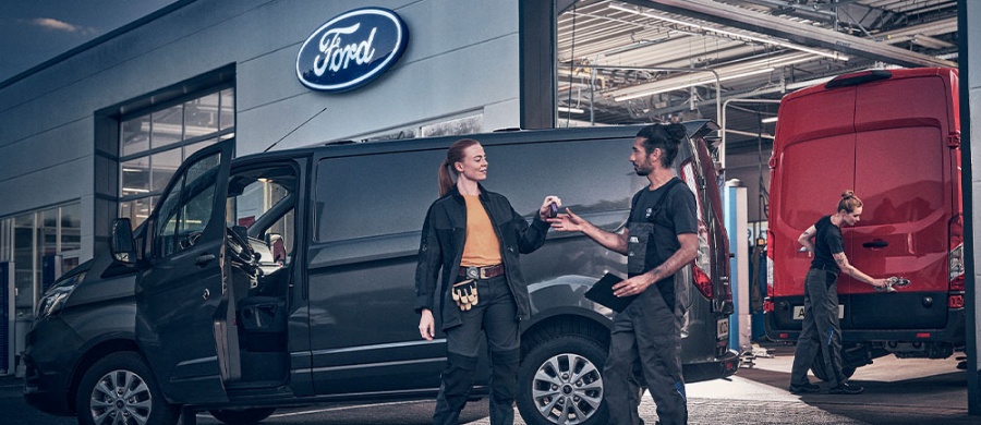 Ford Pro team members greeting a customer at a service van